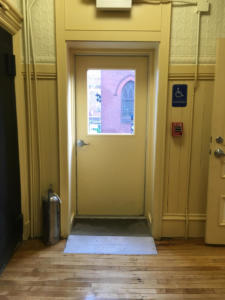 inside door at end of wheelchair ramp at old town hall.