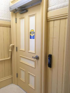 wheelchair accessible front hall bathroom with automatic door opener.